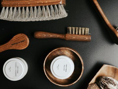 A collection of grooming products displayed on a wooden table.
