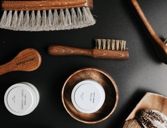 A collection of grooming products displayed on a wooden table.
